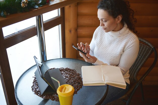 A person sitting at a table, looking at different applications for assistance programs. The setting is a public library or community center.