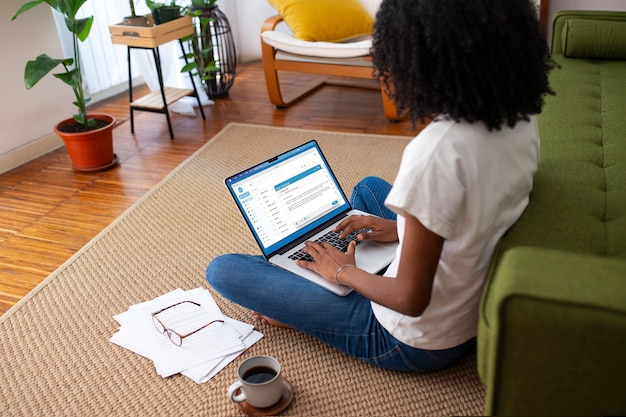 A person sitting at a computer, browsing a website with resources for rental assistance. The website features logos of various non-profit organizations and government agencies. The image suggests research and exploration of alternative aid options.