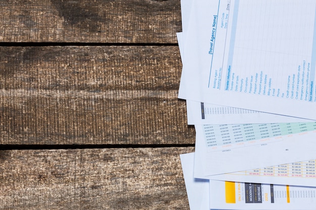 A close-up shot of various documents required for a SNAP application, including a driver's license, pay stubs, bank statements, and a utility bill, neatly arranged on a wooden table.