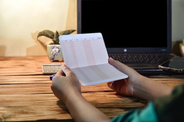 A close-up of a hand holding a rent check, with a background showing a calendar marked with important dates. The image should emphasize the financial aspect of public housing and the importance of timely payments.