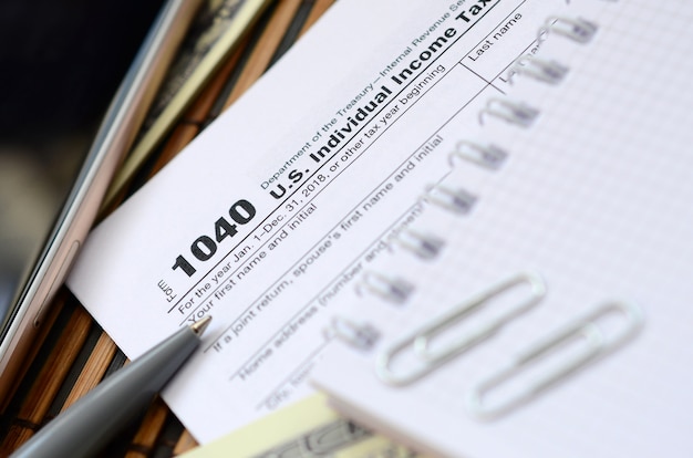 An image of IRS Form 1040 and Schedule EIC, highlighting the sections relevant to claiming the EITC.