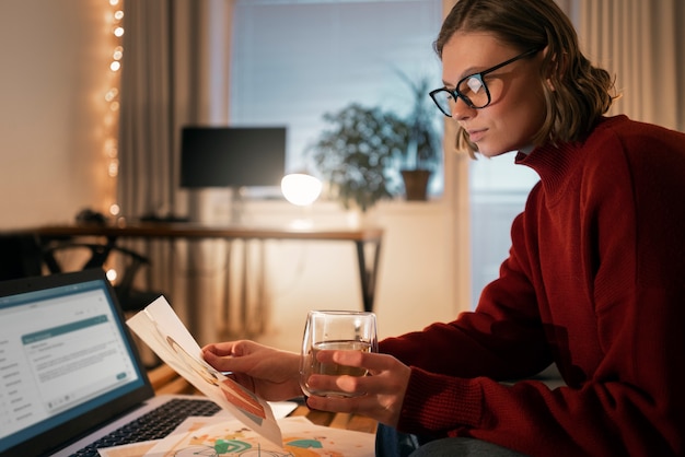 A person reviewing their bank accounts and investment statements on a laptop, focusing on identifying liquid assets suitable for an emergency fund.