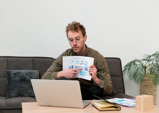 A person on their laptop, with a screen showing a debt repayment plan and charts illustrating the progress made. The image conveys the idea of strategic debt management and financial planning.