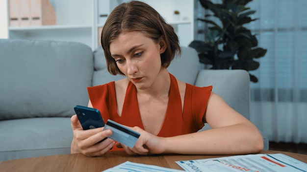 A freelancer using a budgeting app on their smartphone, showing a breakdown of income and expenses with categories like 