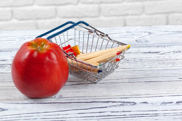 A close-up image of a shopping cart with essential items like groceries, but the prices on the items are exaggeratedly high, visually representing the diminished purchasing power due to inflation.