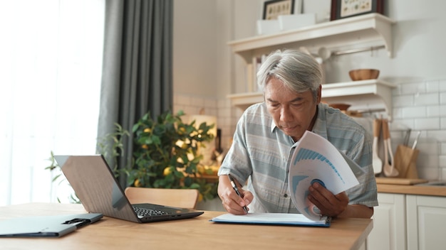A concerned senior looking at a pile of medical bills on a table, highlighting the rising costs of healthcare and the need for financial planning.
