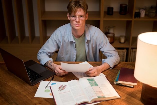 A concerned college graduate looking at a pile of bills, illustrating the common financial stress faced by recent graduates.