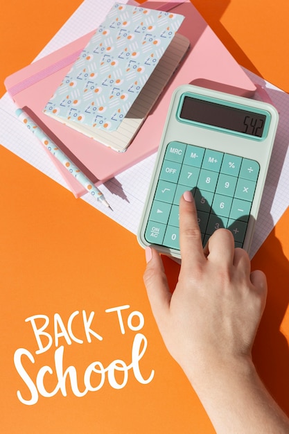 A hand holding a calculator and a statement about student loans, emphasizing careful calculation and strategic planning for debt management.
