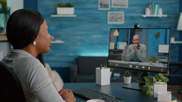 A person participating in an online video conference, demonstrating communication and collaboration in a remote work setting.