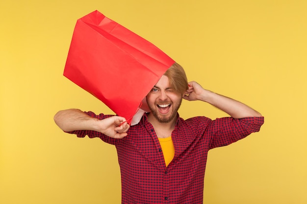 A person holding a shopping bag with money bursting out of it, symbolizing cashback rewards earned through a shopping app.