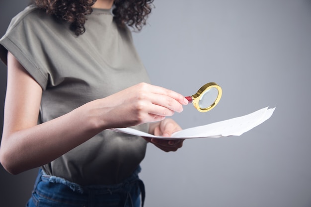 A close-up shot of a hand pointing to a line item on a tax form with a magnifying glass hovering over it, symbolizing the importance of attention to detail in tax preparation.