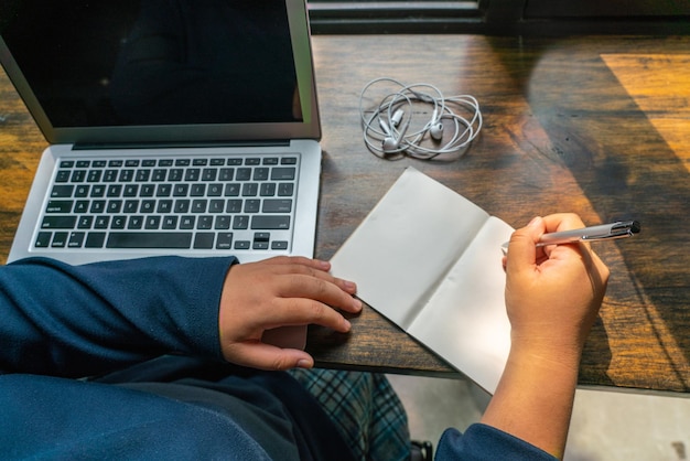 A person filling out tax form 8812 with a pen, with a laptop displaying IRS.gov in the background. The image should feature forms, a laptop, and the tools used for tax preparation. The overall look is organized and easy to understand.