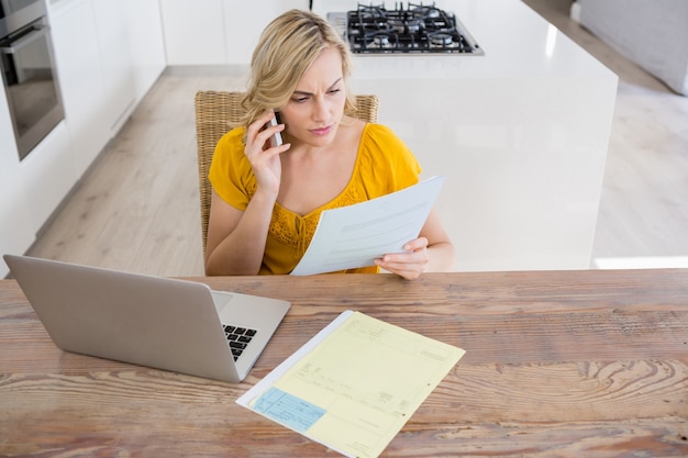 A concerned individual reviewing a Social Security denial letter at their kitchen table. The scene should depict a moment of frustration and determination.