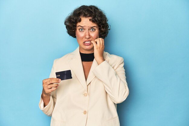 A worried person carefully looking at their credit card statement.